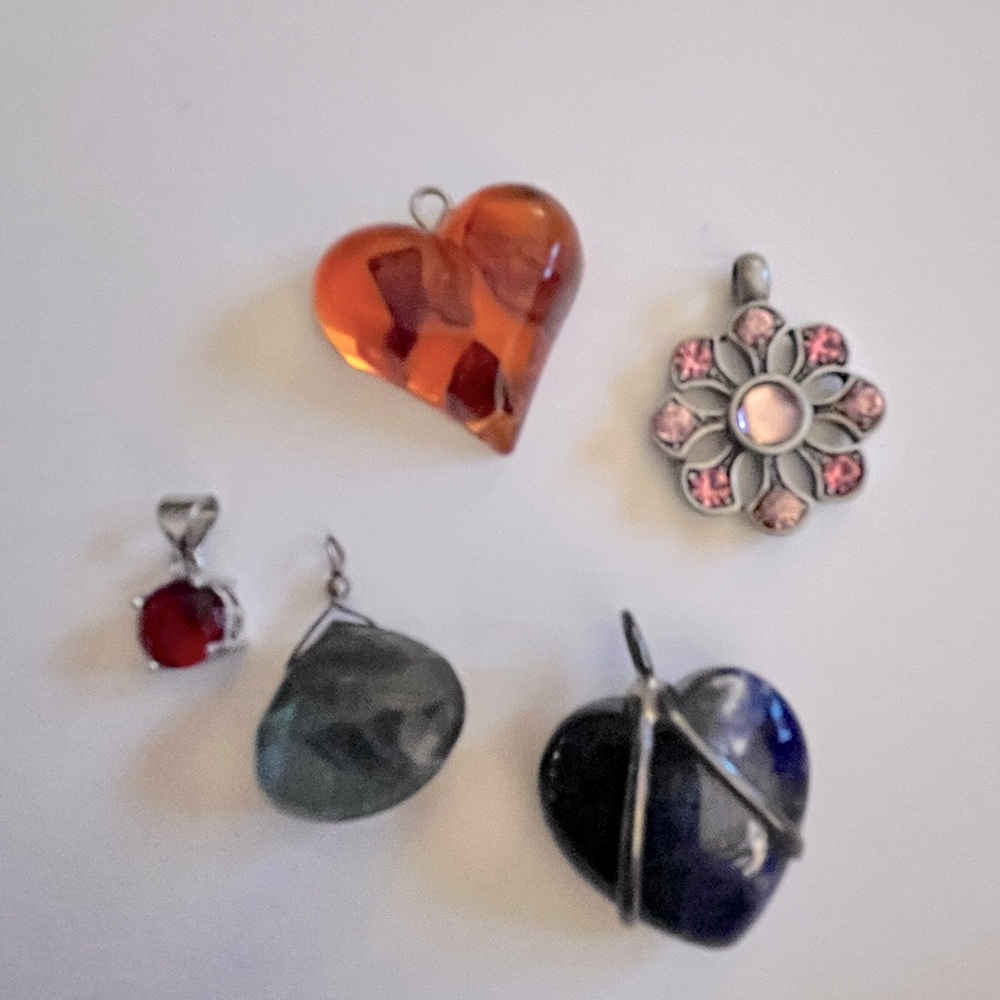 Assorted stone pendants including an amber